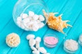 Sea Ã¢â¬â¹Ã¢â¬â¹salt in a glass white stones and Shell for spa and relaxation on a blue background Royalty Free Stock Photo